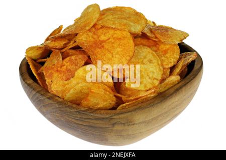 paprika flavored potato chips in a teakwood bowl isolated on white background Stock Photo