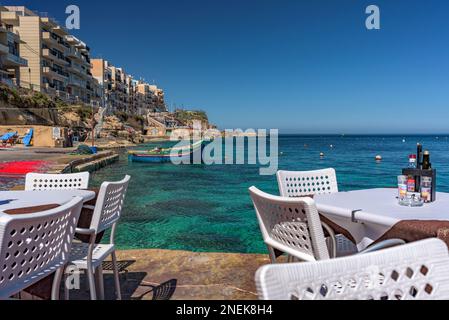 Table setting with sea view in the village of Marsalforn, Gozo Stock Photo