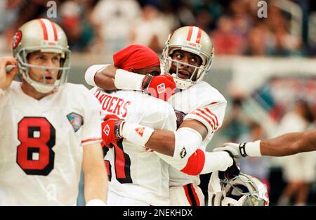 San Francisco 49ers wide receiver Jerry Rice, right, celebrates a first  half touchdown with cornerback Deion Sanders, center, as quarterback Steve  Young (8) looks on at the Georgia Dome in Atlanta on Sunday, Oct. 16, 1994.  The 49ers downed the Falcons