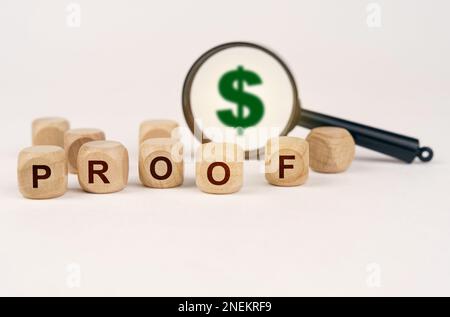 Business concept. On a white surface, a magnifying glass with a dollar symbol and cubes with the inscription - PROOF Stock Photo