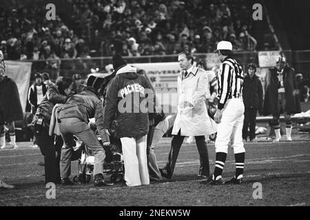 Green Bay Packers coach Bart Starr looks over the cockers as they work on  injured quarterback Lynn Dickey, Nov. 13, 1977 in Milwaukee. The Packers  quarterback was injured on the final play