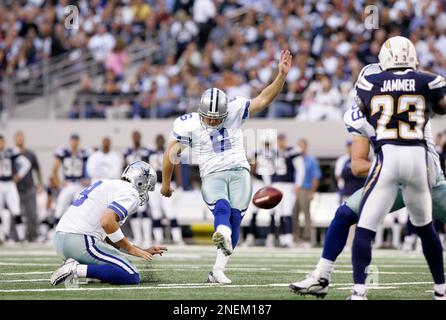 Dallas Cowboys' holder Tony Romo (right) tries to coax Mike