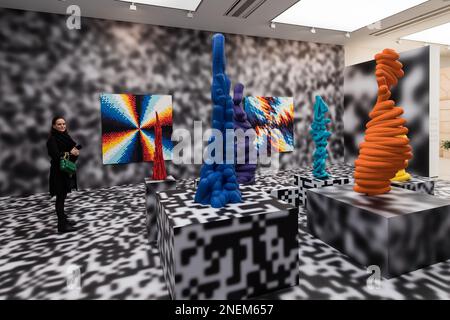 London, UK. 16th Feb, 2023. LONDON, UNITED KINGDOM - FEBRUARY 16, 2023: A gallery staff member looks at works by Felipe Pantone during a press view for Beyond The Streets, the most comprehensive graffiti & street art exhibition to open in the UK, at Saatchi Gallery in London, United Kingdom on February 16, 2023. The exhibition (17 February - 9 May 2023) will feature works of over 100 artists spread over all three floors of London's iconic Saatchi Gallery. (Photo by WIktor Szymanowicz/NurPhoto) Credit: NurPhoto SRL/Alamy Live News Stock Photo