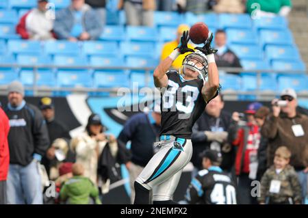 Carolina Panthers (83) wide receiver Louis Murphy leaps into the arms of  (82) tight end Gary Barnidge following Barnidge's touchdown pass reception  from (3) Derek Anderson during third quarter action against the