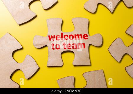welcome to the team is written in a white notebook with calculator, craft colored notepad Stock Photo