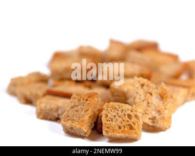 Toasted bread cubes against white background Stock Photo