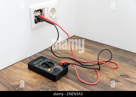 the multimeter is on the table. measuring voltage with a tester. Stock Photo