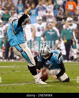 Carolina Panthers place kicker John Kasay, center, is consloed by teammates  punter Jason Baker, left, and guard Mackenzy Bernadeau (73), right, ater  missing a field goal that would have won the game