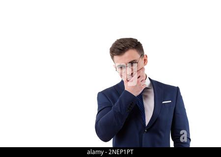 Handsome male businessman in a suit conceived about solving a problem. Holding on to the beard in studio on a white background. Stock Photo