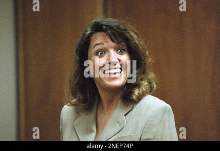 Whitewater figure Susan McDougal smiles as she talks with her attorney ...