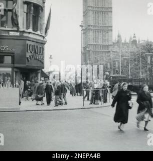 London, England. 1953. A view from the corner of Parliament Street looking towards the Houses of Parliament and the Great Clock of Westminster, more commonly known as Big Ben. The street is decorated with banners in preparation for the coronation of Queen Elizabeth II, which took place on 2nd June 1953. Stock Photo