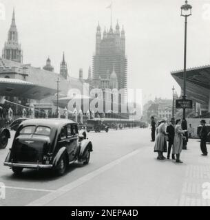 London, England. 1953. A view from Parliament Street looking towards the Houses of Parliament and Victoria Tower.  Along the street are temporary stands especially erected for the coronation of Queen Elizabeth II, which took place on 2nd June 1953. Stock Photo