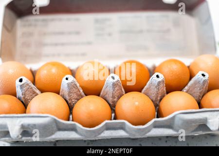 Pasture raised farm fresh dozen brown eggs closeup from store bought from farmer in carton box container with eggshells texture Stock Photo