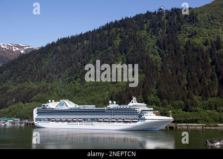 The view of moored large cruse liner and its reflections in Juneau town (Alaska). Stock Photo