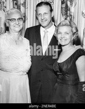 1963 Mrs. Stan Musial sits in front of a Musial family photo. - Historic  Images