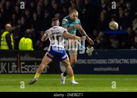 Blake Austin #6 of Leeds Rhinos kicks ahead despite the tackle of Danny Walker #16 of Warrington Wolves during the Betfred Super League Round 1 match Warrington Wolves vs Leeds Rhinos at Halliwell Jones Stadium, Warrington, United Kingdom, 16th February 2023 (Photo by Craig Thomas/News Images) in, on 2/16/2023. (Photo by Craig Thomas/News Images/Sipa USA) Credit: Sipa USA/Alamy Live News Stock Photo