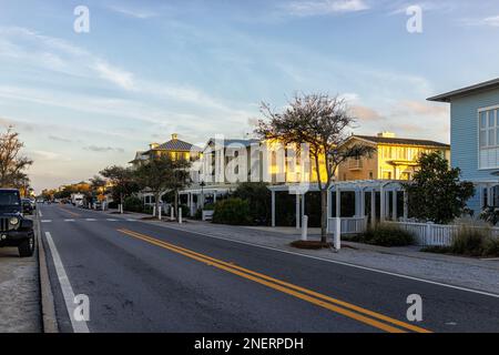 Seaside, USA - January 14, 2021: Colorful wooden beach buildings in Florida town on panhandle gulf of mexico coast at yellow sunset and east county hi Stock Photo