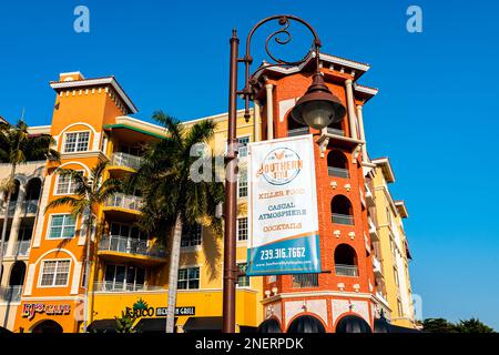 Naples, USA - January 29, 2021: Bayfront residential street condo architecture building with banner sign for Southern Style restaurant serving casual Stock Photo