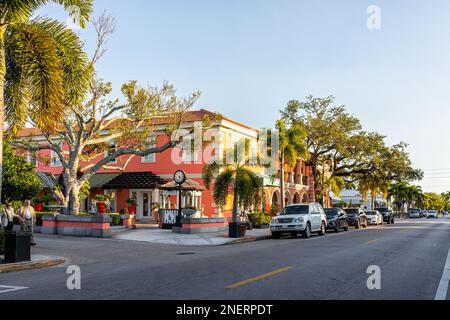 Naples, USA - January 29, 2021: Old town Naples, Florida downtown street district road at sunset with restaurants and designer boutiques shops Stock Photo