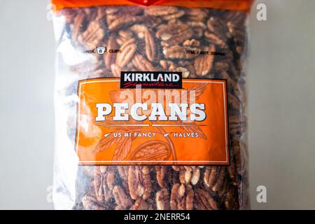 Naples, USA - November 22, 2021: Closeup of sign label and product closeup of Costco Kirkland signature bag package of raw unroasted pecan halves peca Stock Photo