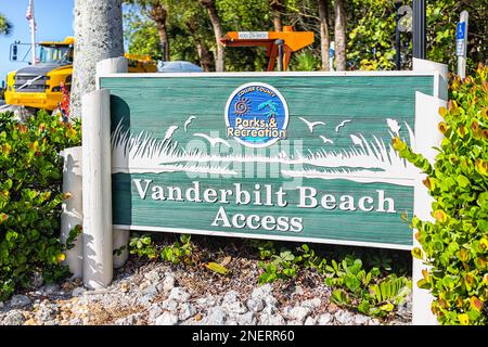 Naples, USA - December 28, 2021: Vanderbilt beach in Florida southwest with access boardwalk sign road closed under construction on sunny day with pal Stock Photo