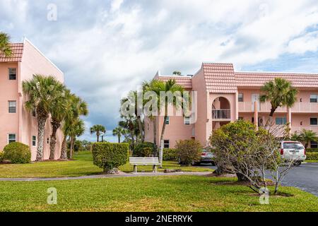 Naples, USA - February 5, 2022: Turtle Lake condo condominium association residential buildings with walking path by parking lot in Southwest Florida Stock Photo