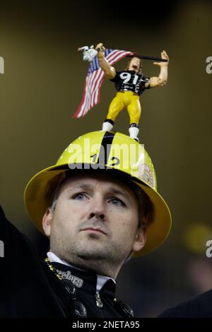 Pittsburgh Steelers fan Doug Stradley, of Pittsburgh, wears a helmet with a  figurine of Aaron Smith on it, at an NFL football game against the Detroit  Lions in Detroit, Sunday, Oct. 11