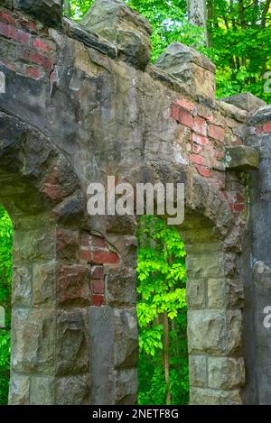 Archways in the outer wall of Squires Castle, and abandoned and fire-gutted old mansion in a Cleveland, Ohio, area park Stock Photo