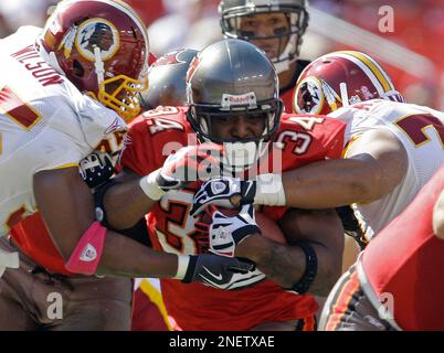 Atlanta Falcons linebacker Robert Lyles (54) pulls on the jersey of  Washington Redskins running back Earnest Byner (21) during first quarter  NFL Divisional playoff action, Jan. 4, 1992, at RFK Stadium in