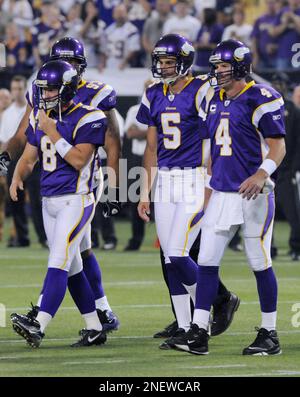 Minnesota Vikings' Jim Kleinsasser (40) gives a friendly slap to the helmet  to Vikings punter/holder Chris Kluwe after Ryan Longwell (right) kicked the  game winning field goal in overtime at the Metrodome