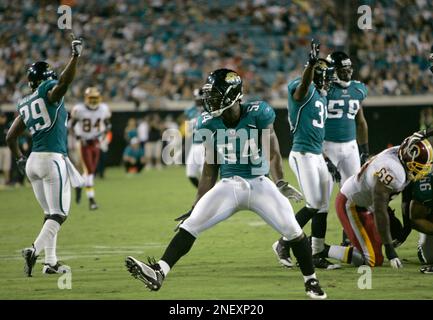 Jacksonville Jaguars' Brian Iwuh (59) and Jorge Cordova (58) pummel  Philadelphia Eagles punter Dirk Johnson after he punted the ball at Lincoln  Financial Field in Philadelphia, Pennsylvania, Sunday, October 29, 2006. The