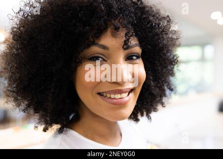 Face of happy biracial businesswoman looking at camera in office Stock Photo