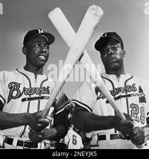 Milwaukee Braves outfielder Hank Aaron, center, jokes with St