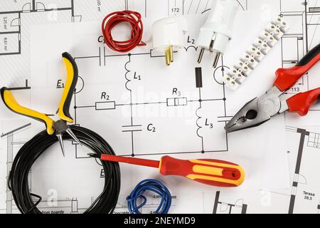 Flat lay composition with electrician's tools on house plan sheets Stock Photo