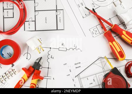 Flat lay composition with electrician's tools on house plan sheets Stock Photo