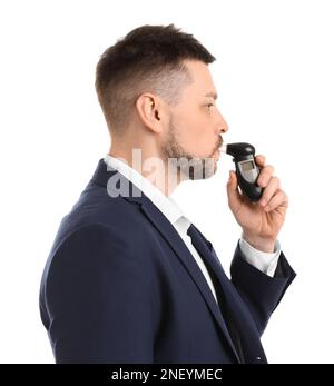 Man blowing into breathalyzer on white background Stock Photo