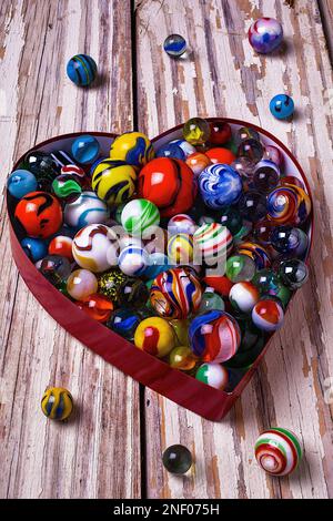 Heart Box With Marbles On Wooden Boards Stock Photo