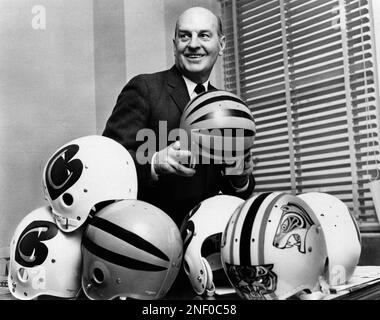 Paul Brown, President of the New Cincinnati Bengals of the American  Football League, is trying to select the design, helmets, Jan. 3, 1968 in  Cincinnati, to be worn by his team when