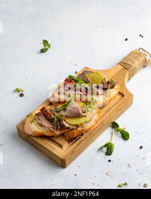 bruschetta with beef and dried tomatoes. High quality photo Stock Photo