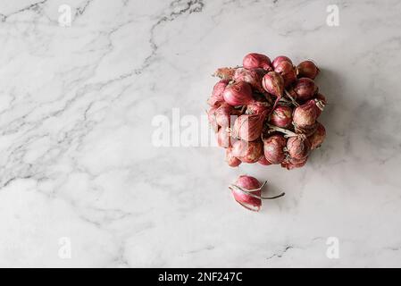 small shallots on a light background from Thailand. High quality photo Stock Photo