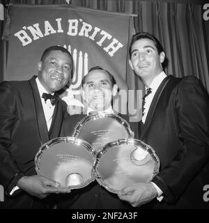 A trio of baseball stars displays awards received in New York Jan