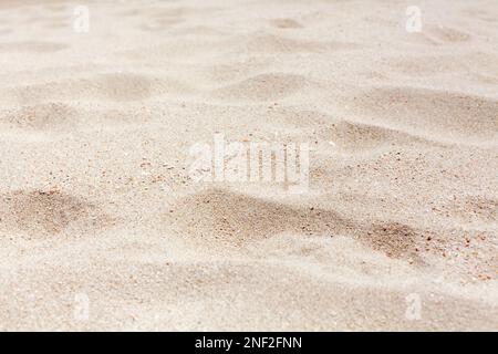 White sand texture close up background, wavy sandy pattern, natural dry sand grains backdrop, clean beige rippled sand surface top view, desert dune Stock Photo