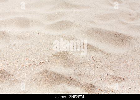 White sand texture close up background, wavy sandy pattern, natural dry sand grains backdrop, clean beige rippled sand surface top view, desert dune Stock Photo