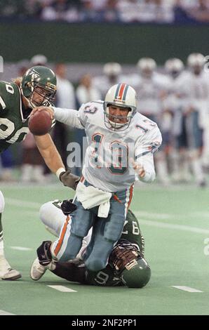 Miami Dolphins quarterback Dan Marino is sacked by New York Jets defensive  end Marvin Washington for a two yard loss in the second quarter of NFL play  in East Rutherford, New Jersey, Sunday, Sept. 29, 1991. Jets Dennis Byrd is  at left. (AP Photo/Mark