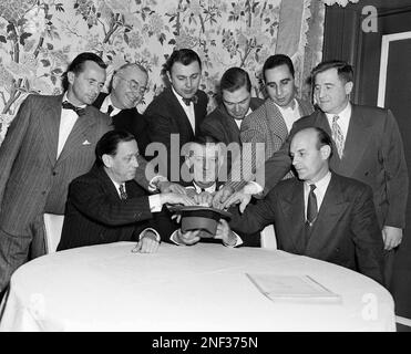 Bert Bell, center, of Philadelphia, receives congratulations in Chicago  Jan. 20, 1949 fronm George Halas Jr., left, and Charles W. Bidwell Jr.  after being presented with a 10-year contract to continue to