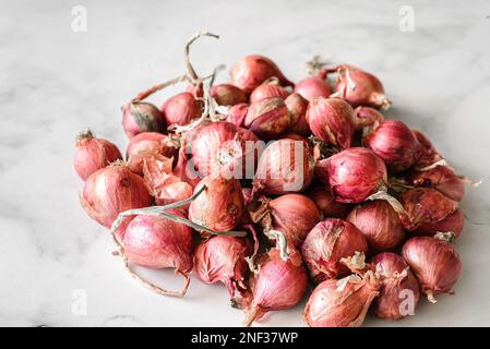 small shallots on a light background from Thailand. High quality photo Stock Photo
