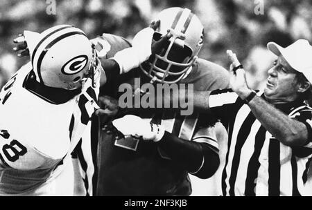 Green Bay Packers' Ezra Johnson (78) and Detroit Lions' Bill Fifer (70)  slug it out in the closing minutes of NFL game in Pontiac, Mich., Sept. 3,  1978 as Green Bay upset the Lions, 13-7. Referee Pat Haggerty, right, tries  to cautiously break up the pl