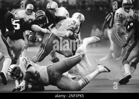 Houston Oilers' fullback Earl Campbell (34) turns the left corner in the  first quarter to pick up 12 yards in the NFL game, Oct. 11, 1981 in Houston.  Seattle Seahawks John Harris (