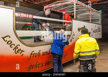 PRODUCTION - 16 February 2023, Brandenburg, Welzow: Carnivalists of the Welzower Carneval Club 1956 e.V. are putting the finishing touches to the superstructures on their float, with which they will take part in the Cottbus 'Zug der fröhlichen Leute' on Carnival Sunday. More than 50 members of the club will accompany the float under the motto 'Locker froh und heiter, beim WCC geht's immer weiter'. Starting at 1:11 p.m., more than 3,000 participants will present about 90 images from the region, from Berlin and from Saxony. Several tens of thousands of visitors are again expected to attend the l Stock Photo