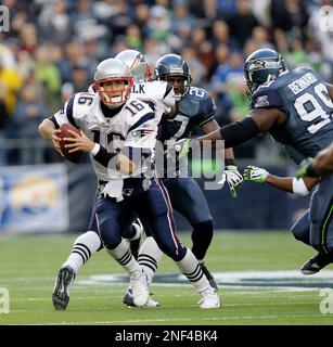 New England Patriots' quarterback Matt Cassel, left is pursued by Seattle  Seahawks defensive tackle Rocky Bernard (99) during an NFL football game  Sunday, Dec. 7, 2008, in Seattle. (AP Photo/Elaine Thompson Stock